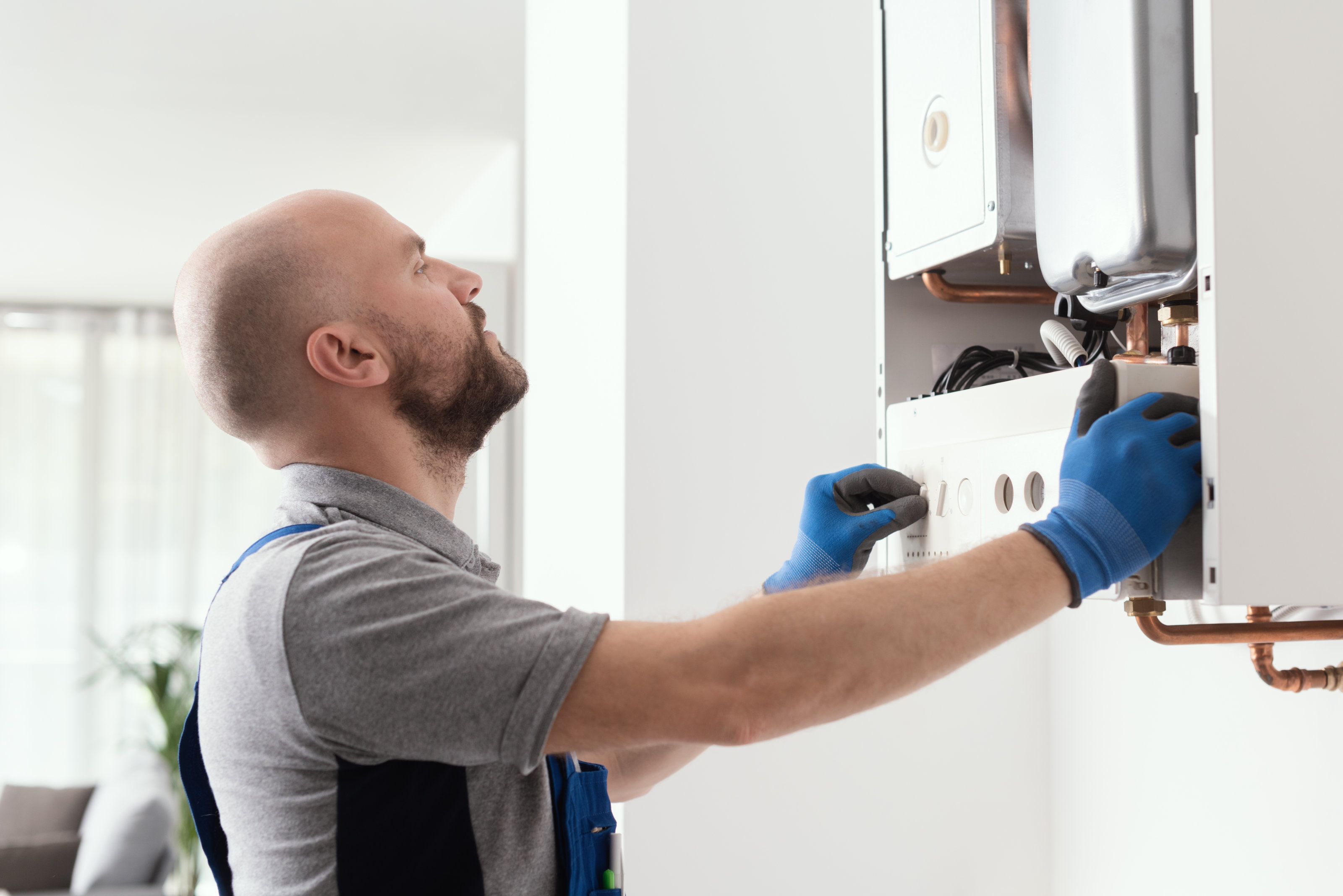 A gas engineer working on a boiler