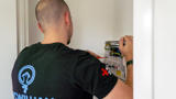An electrician working on a consumer unit