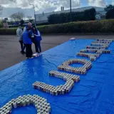 Photograph of the Fintrano logo made of cans