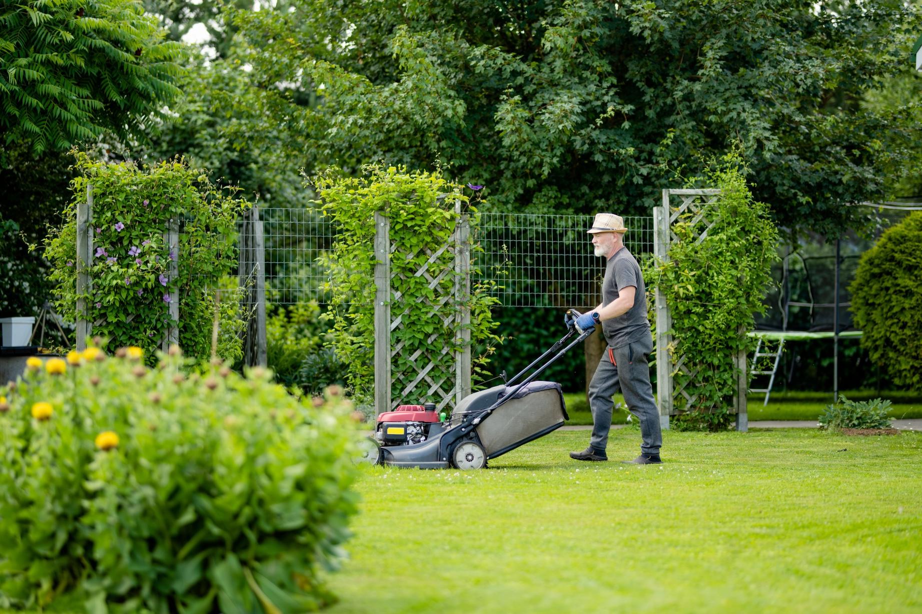 A man mowing a lawn.